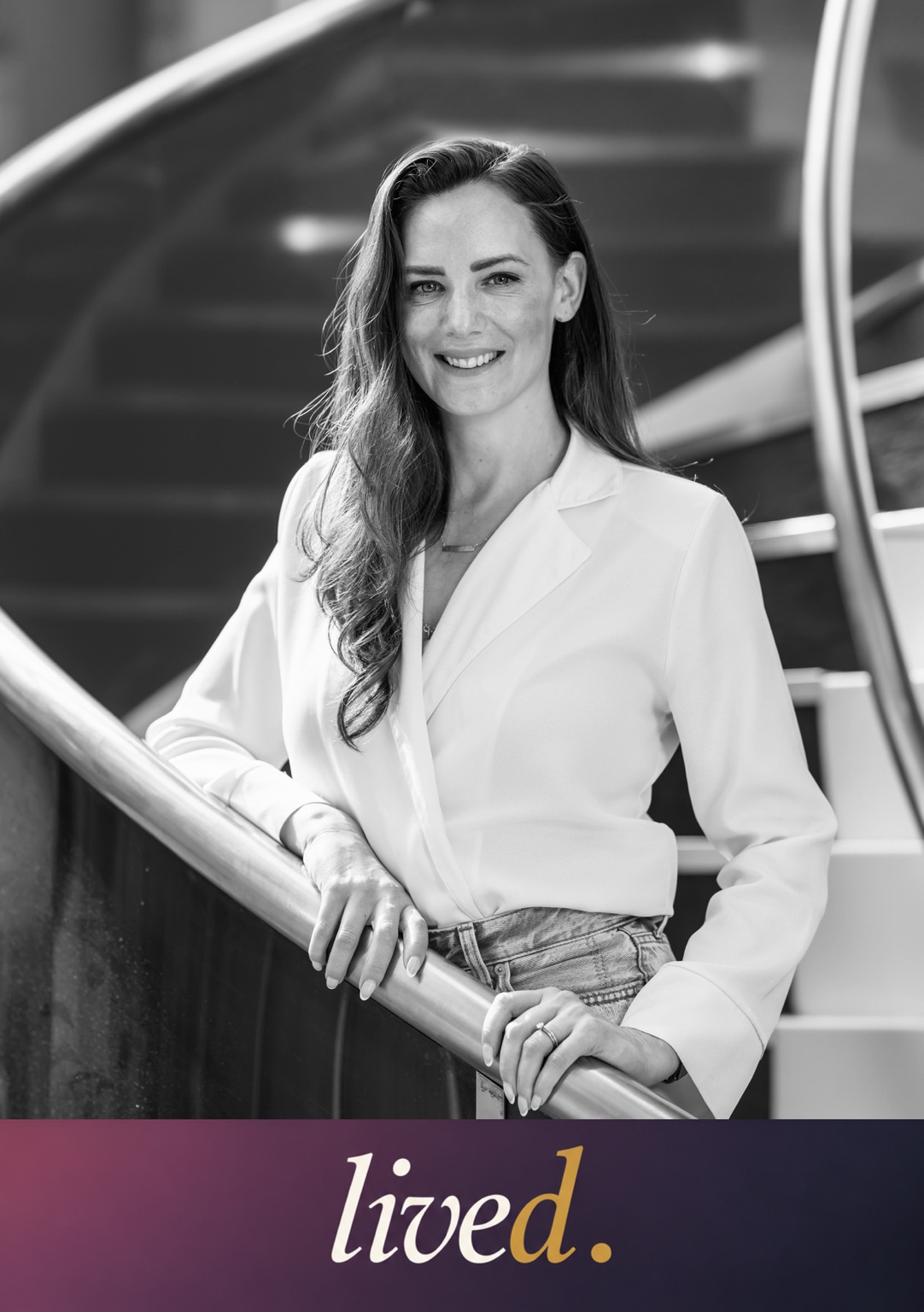 Katherine Russell on a curved staircase, in black and white